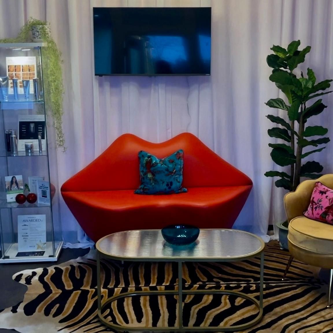 The Fairy ToxMother luxury med spa interior with red lips couch